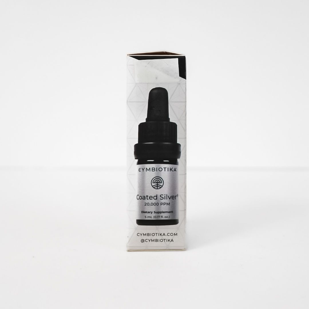 Small dropper bottle of skincare serum in clear packaging on a white background