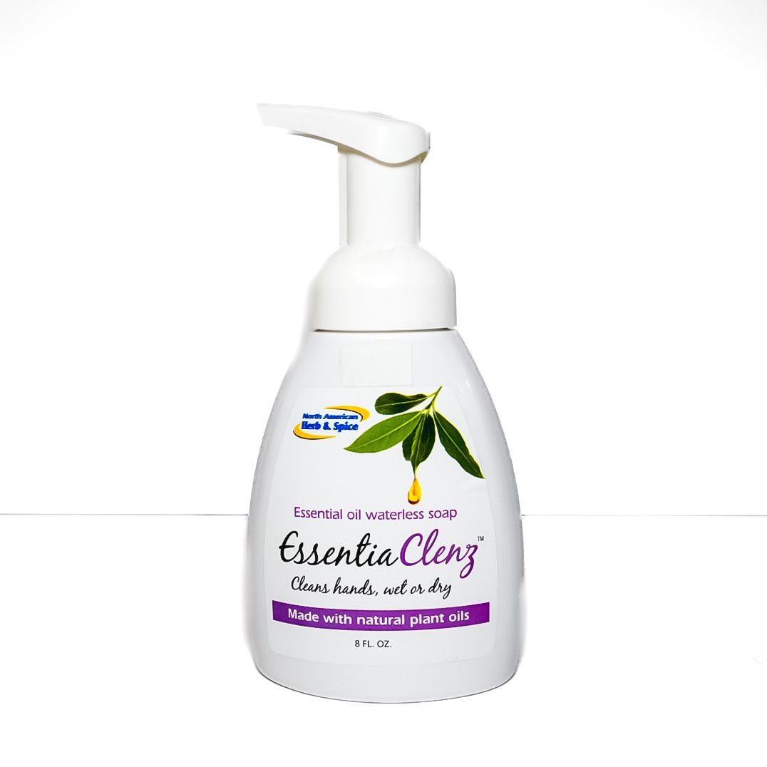 White pump bottle of Essential Clenz hand soap with green leaf graphic and purple label on a white background