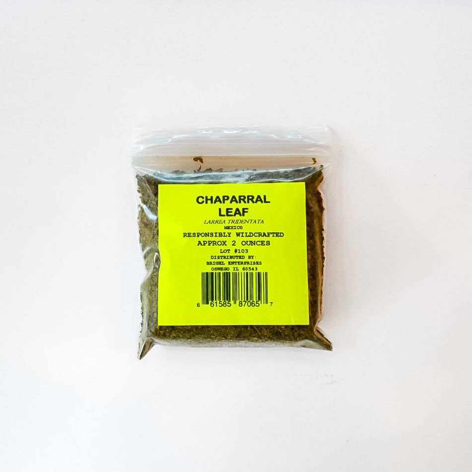 Clear plastic bag of dried chaparral leaf tea with a bright yellow label on a white background