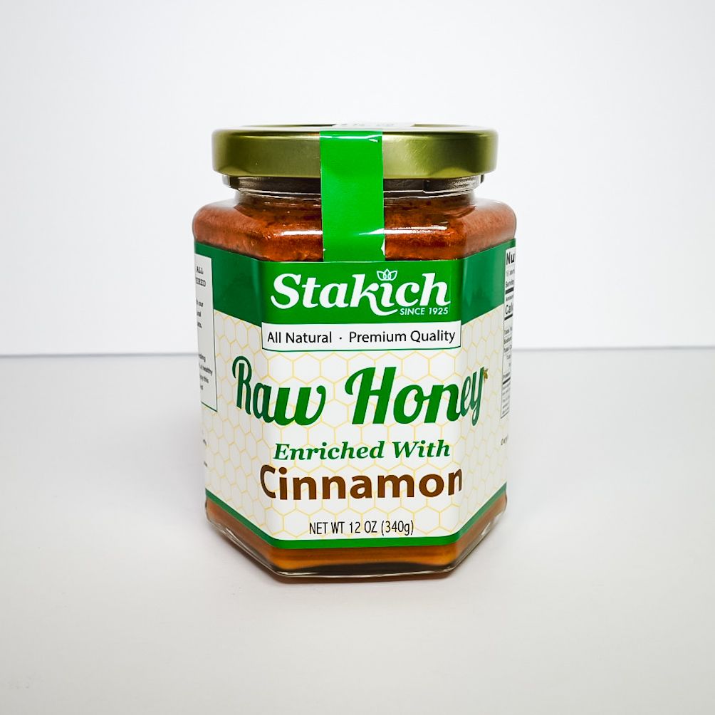 Jar of honey with green lid and nutrition label, shown on a white background