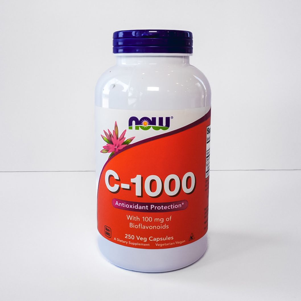 White vitamin supplement bottle with orange label showing Supplement Facts panel