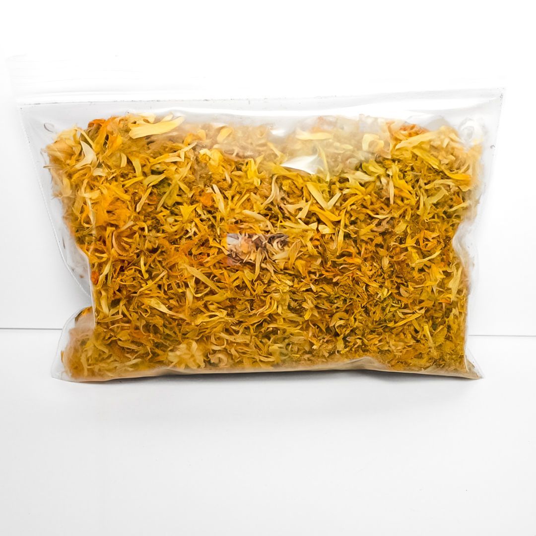 Plastic bag of dried calendula flowers with a bright yellow label on a white background