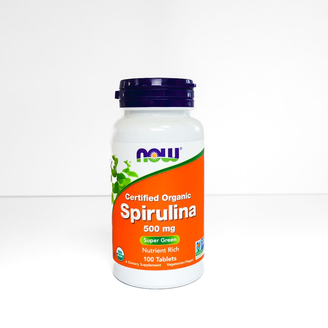 NOW certified organic Spirulina supplement bottle with orange label on white background