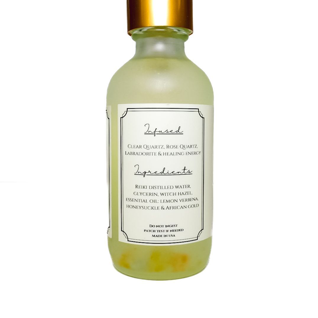 Small frosted glass pump bottle with gold cap and white label on a white background