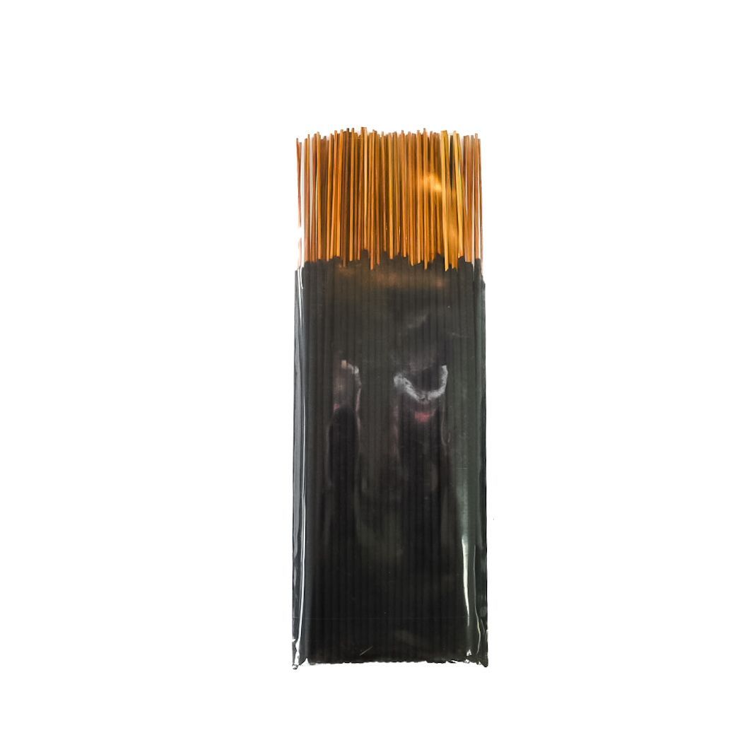 Black packaged item with a yellow label and brown sticks at the top, isolated on white background
