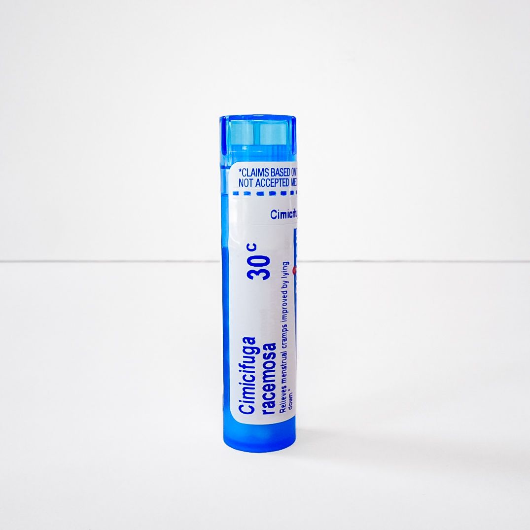 Blue-topped white medicine vial labeled “Cimetidine” standing upright on a plain background