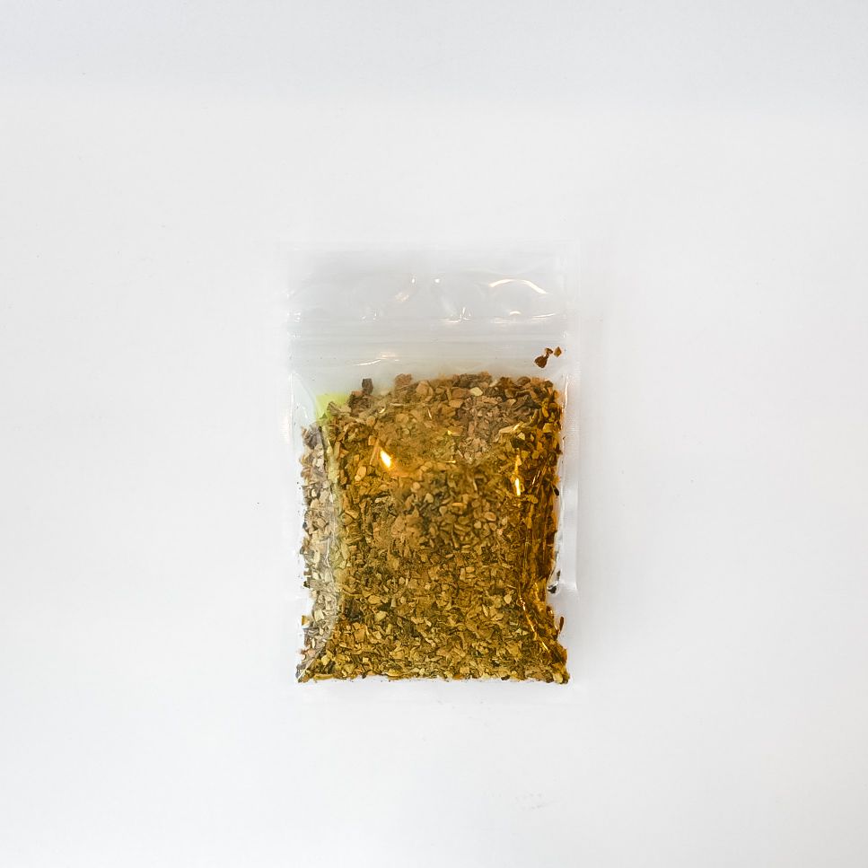 Small clear bag of dried dandelion root with a bright yellow label on a white background