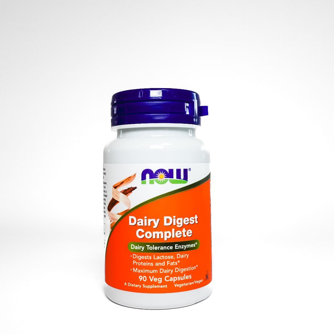 Now Dairy Digest Complete supplement bottle with blue cap and orange label on white background