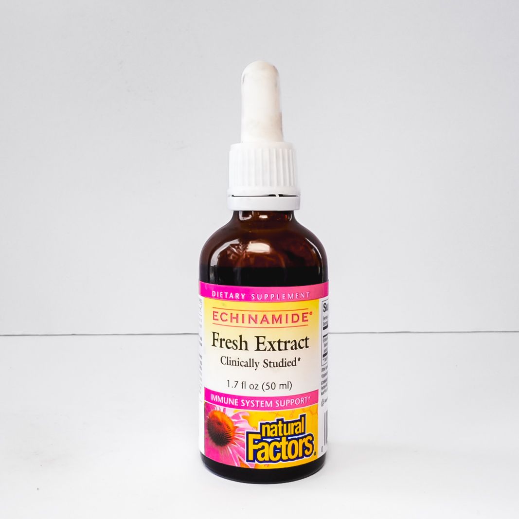 Amber dropper bottle of Fresh Extract Nicinamide serum with pink and yellow label on white background