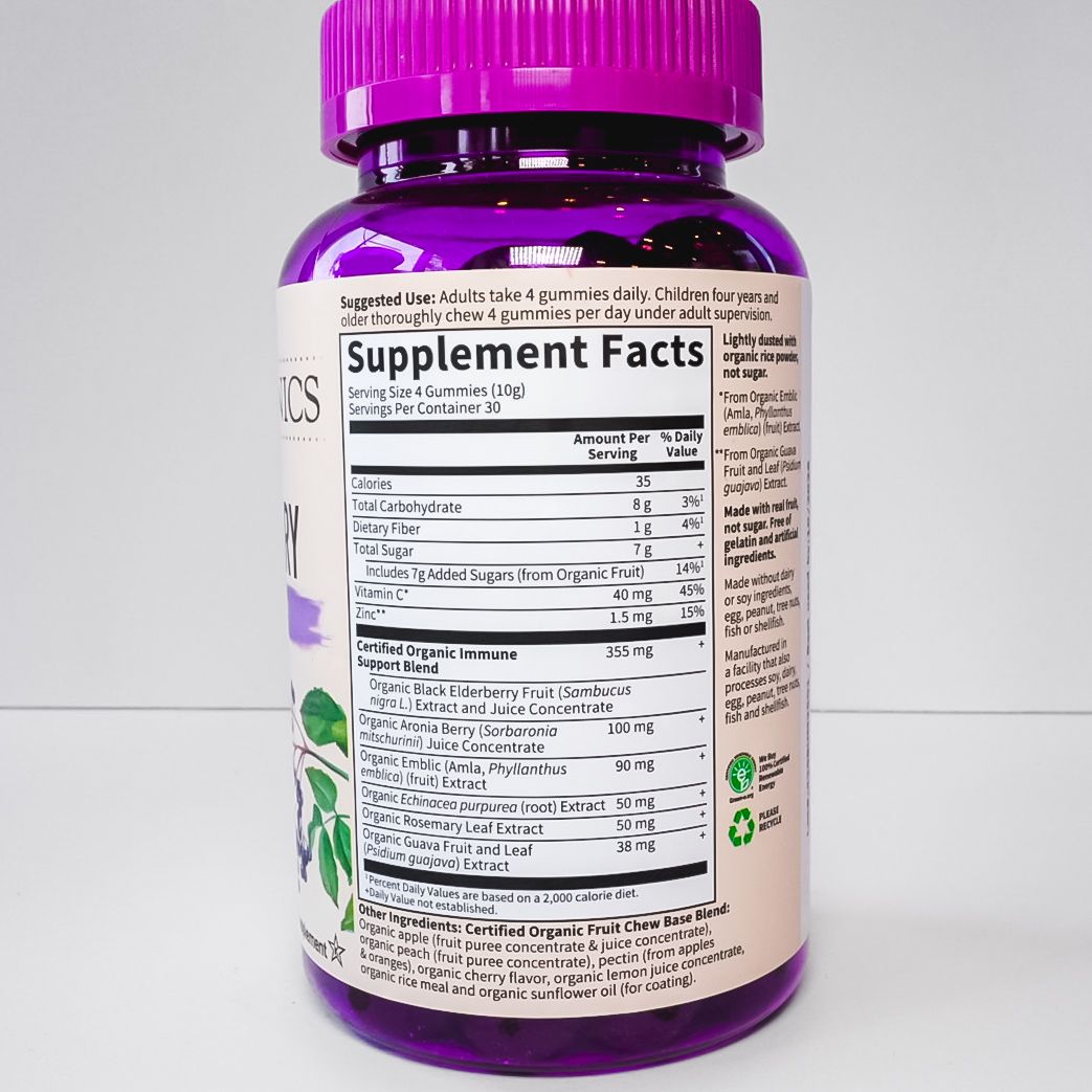 Purple bottle of Organics Elderberry supplement with a magenta cap and white label on a light background