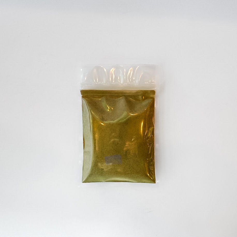 Small clear bag of yellow-brown powdered product with a bright yellow label on a white background