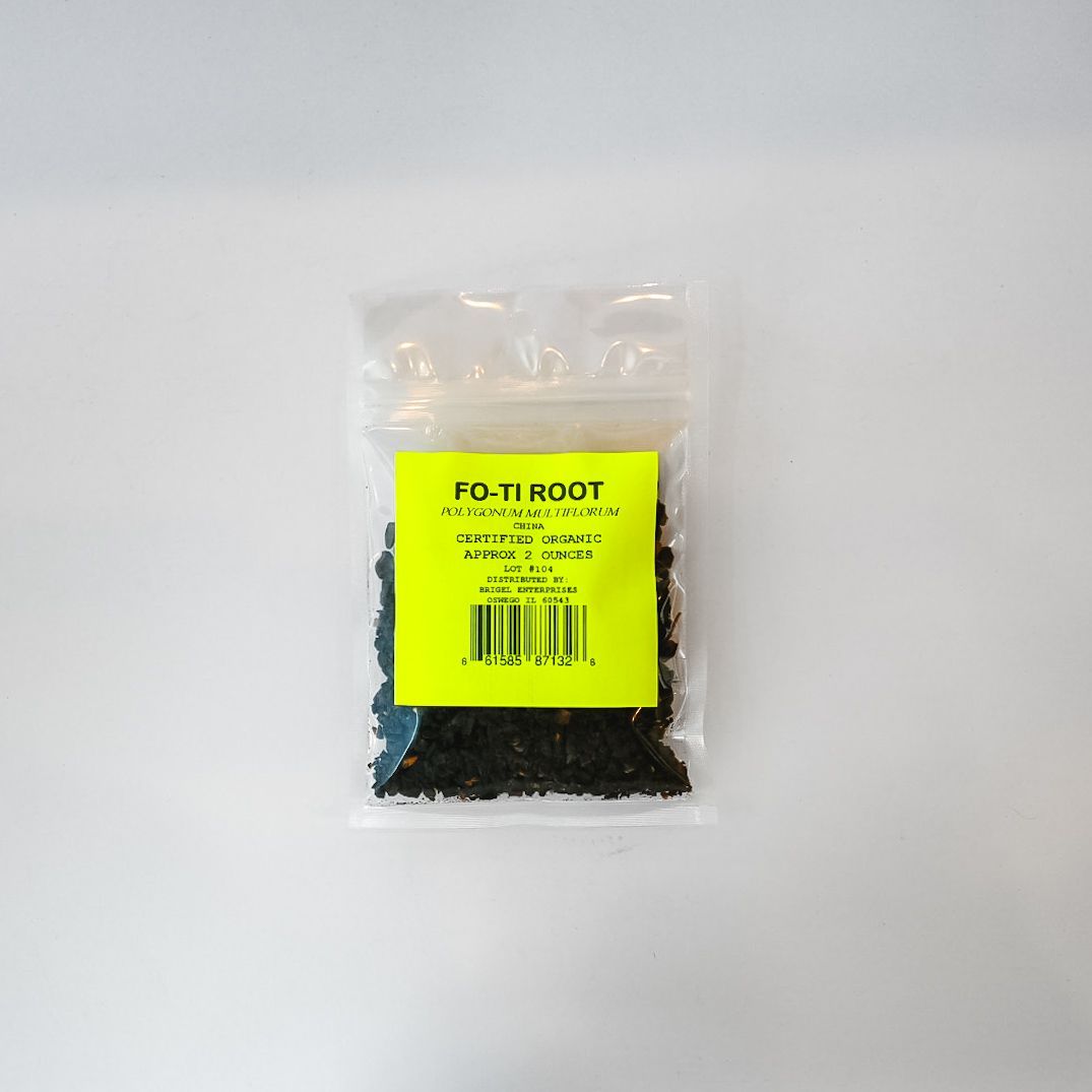Small clear plastic bag of black material with a bright yellow label on a white background