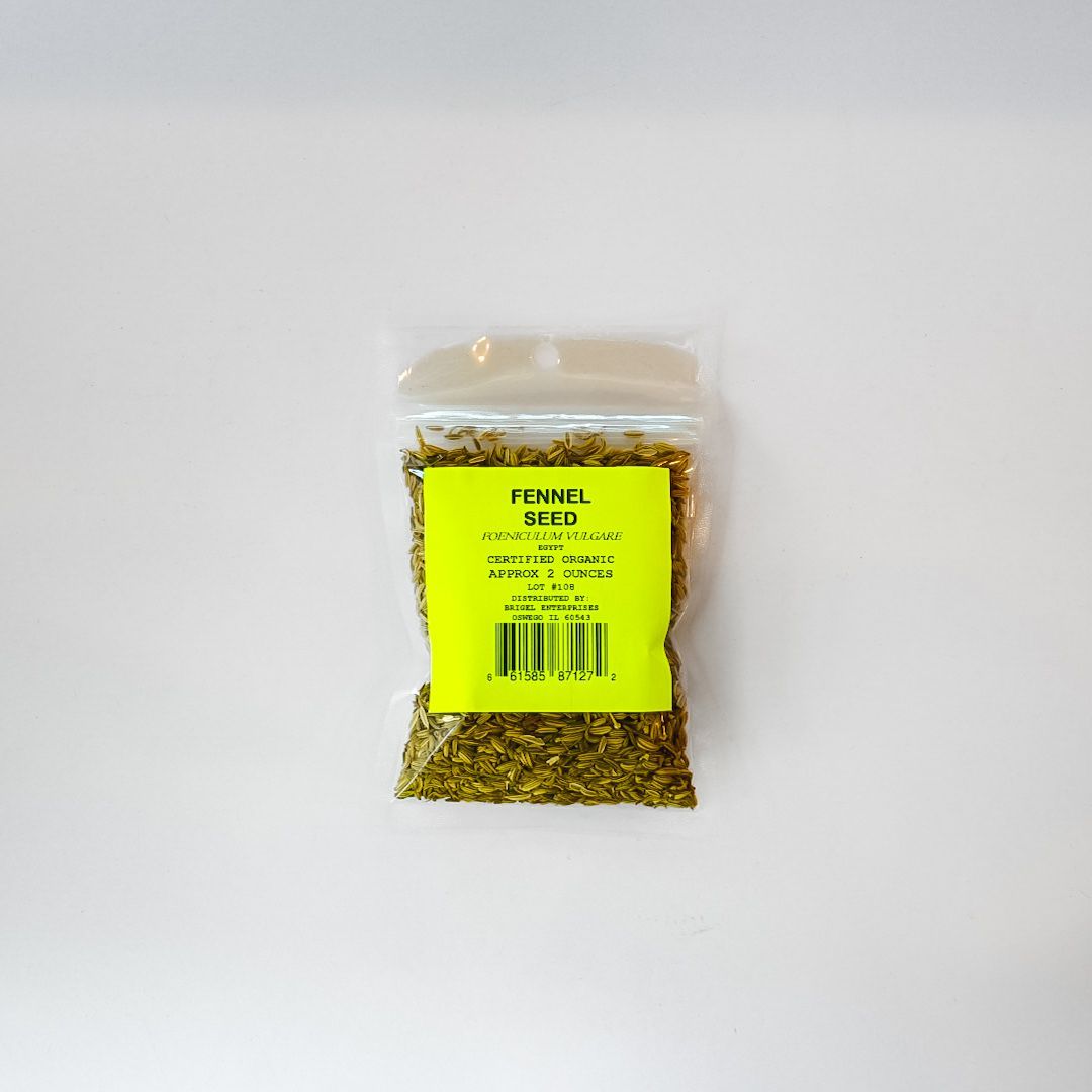 Small clear plastic bag of yellow-green dried herbs with a bright green label on a white surface