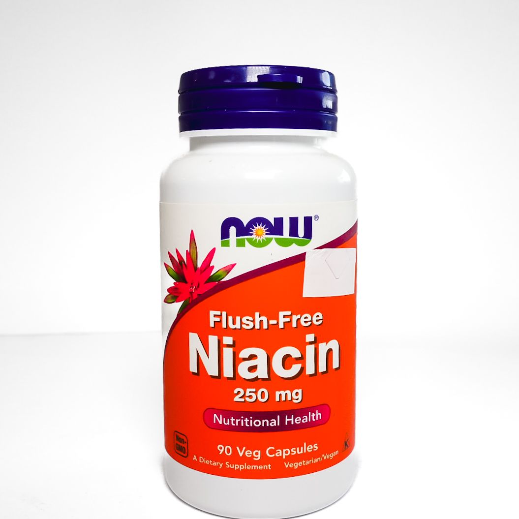 Bottle of NOW Flush-Free Niacin 250 mg supplement with white and orange label and purple cap