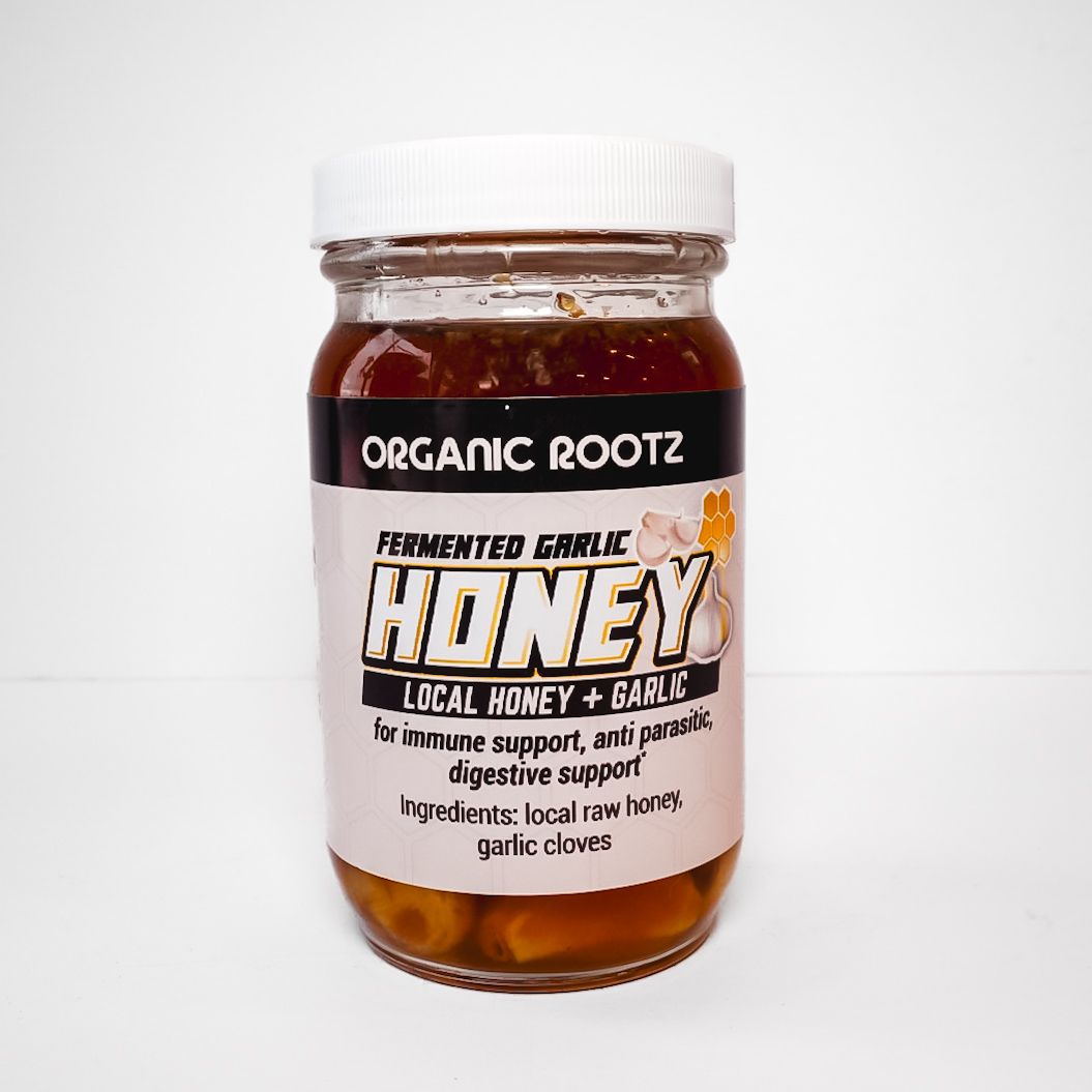 Jar of Organic Rootz fermented local honey with garlic and herbs, white label and cap