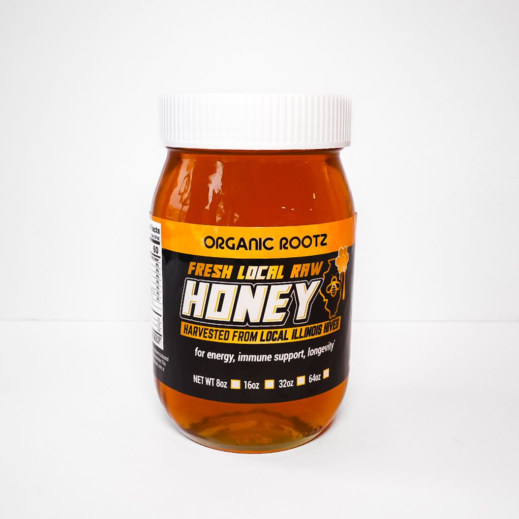 Orange honey jar with white lid and black label on a white background