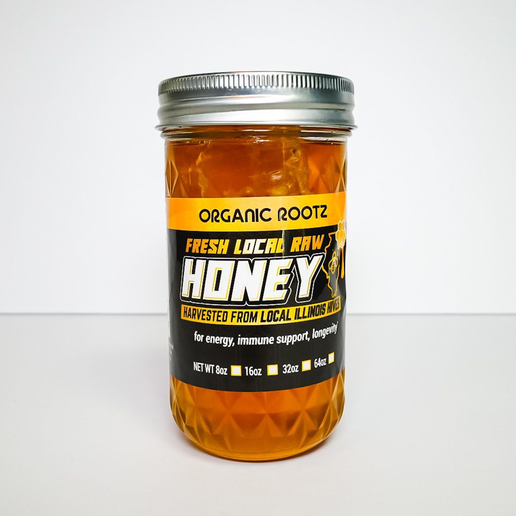 Orange honey jar with white lid and black label on a white background
