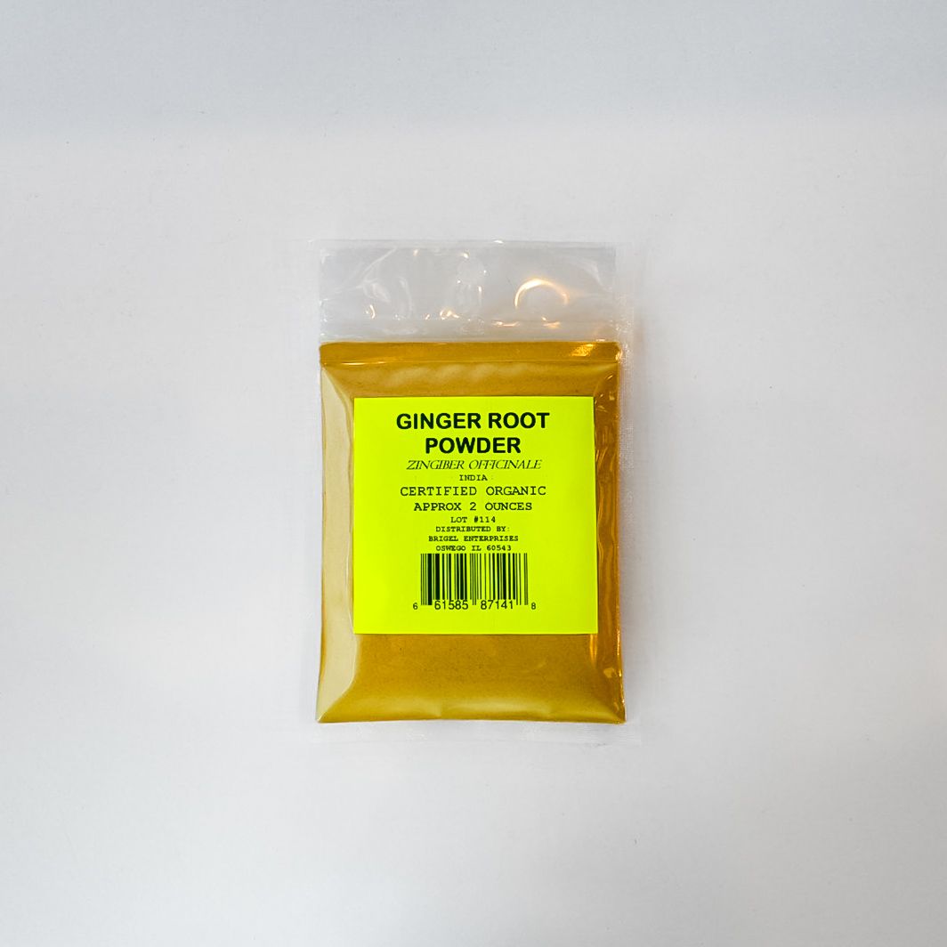 Clear plastic bag of yellow ginger root powder on a white background