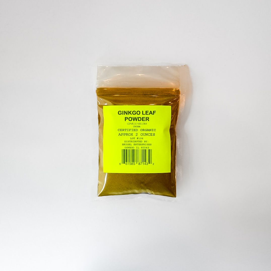 Clear bag of green powder with a bright yellow label on a white background