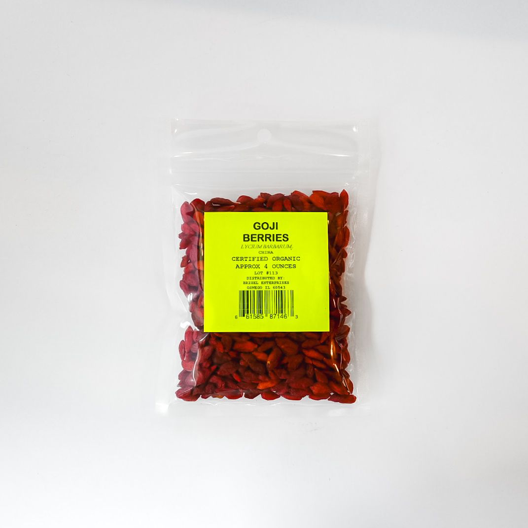 Clear plastic bag of red dried berries with a bright yellow label on a white background