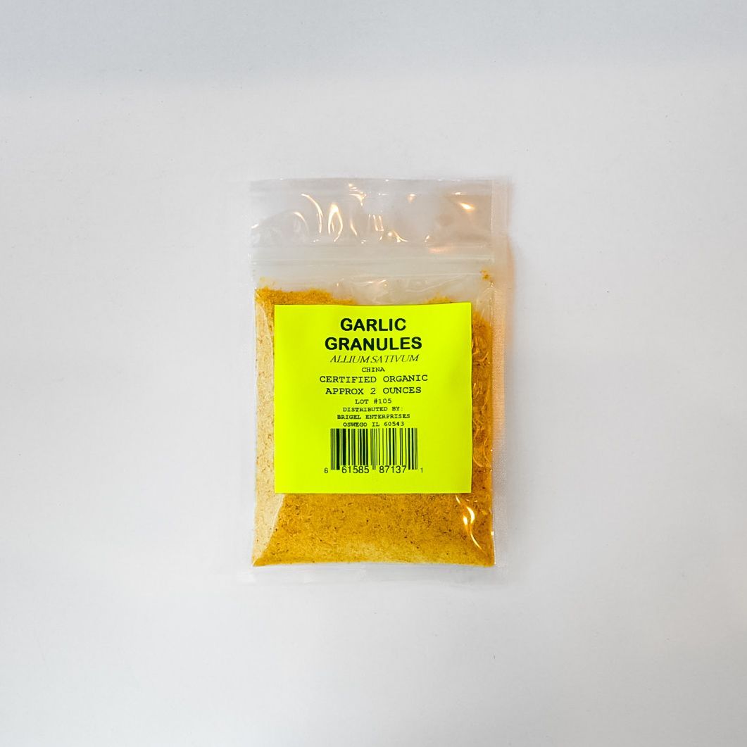 Clear plastic bag of yellow garlic granules with a bright green label on a white background