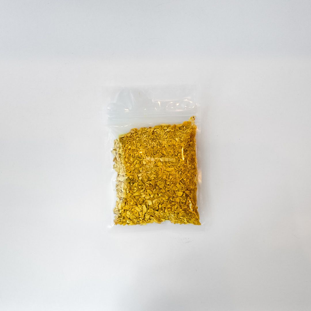 Clear plastic bag of dried ginger root with a yellow label on a white background