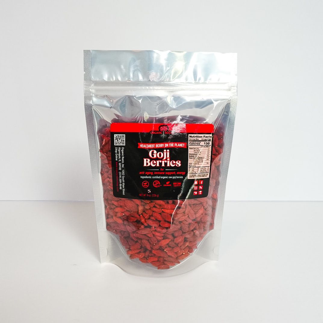 Clear plastic bag of red dried hibiscus flowers with a black label, standing on a white background