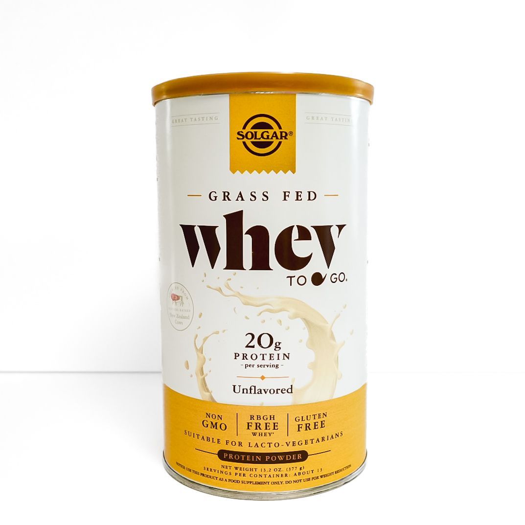 Yellow can of grass-fed whey protein with white label and gold lid.