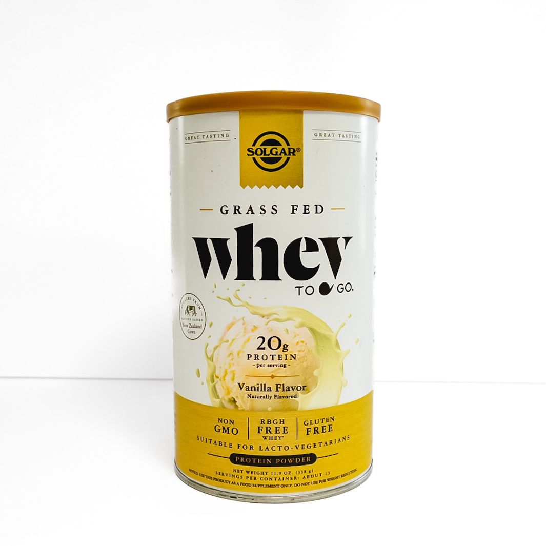 Gold and white Solgar Grass Fed Whey protein container with yellow label on a white background