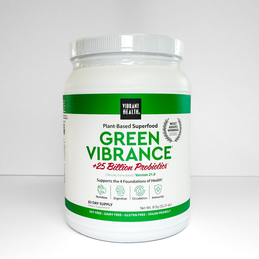 White jar of Green Vibrance probiotic powder with green and red label on a plain background