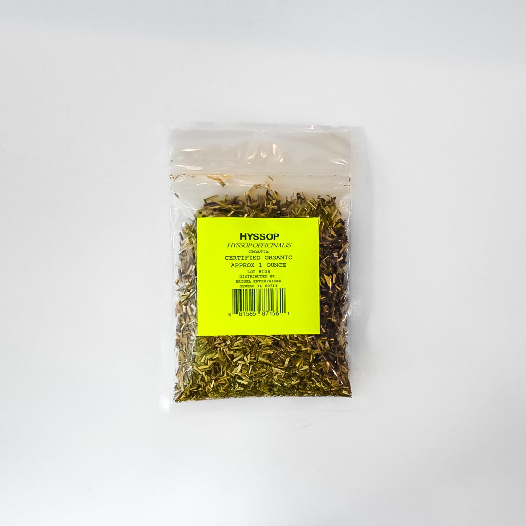Clear plastic bag of dried herbs with a bright yellow label on a white background