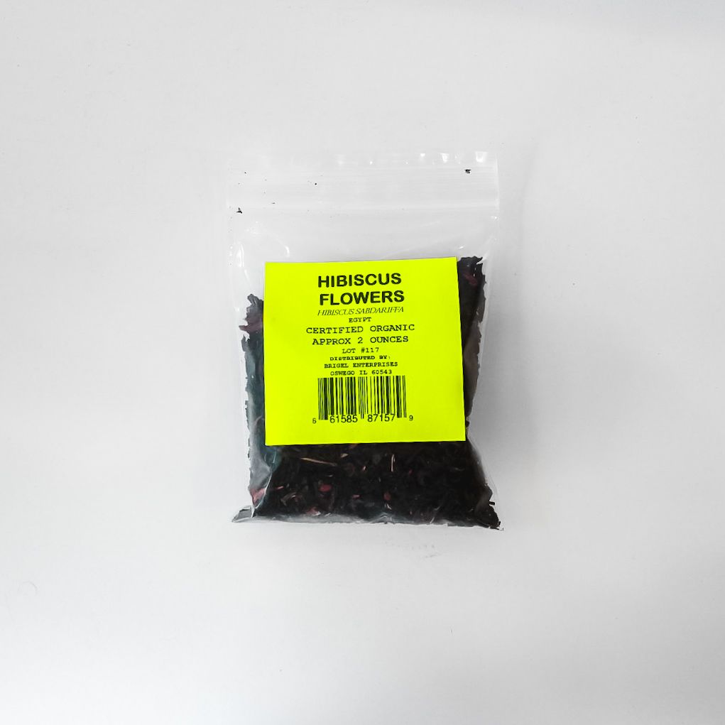Small clear bag of dried hibiscus flowers with a bright yellow label on a white background
