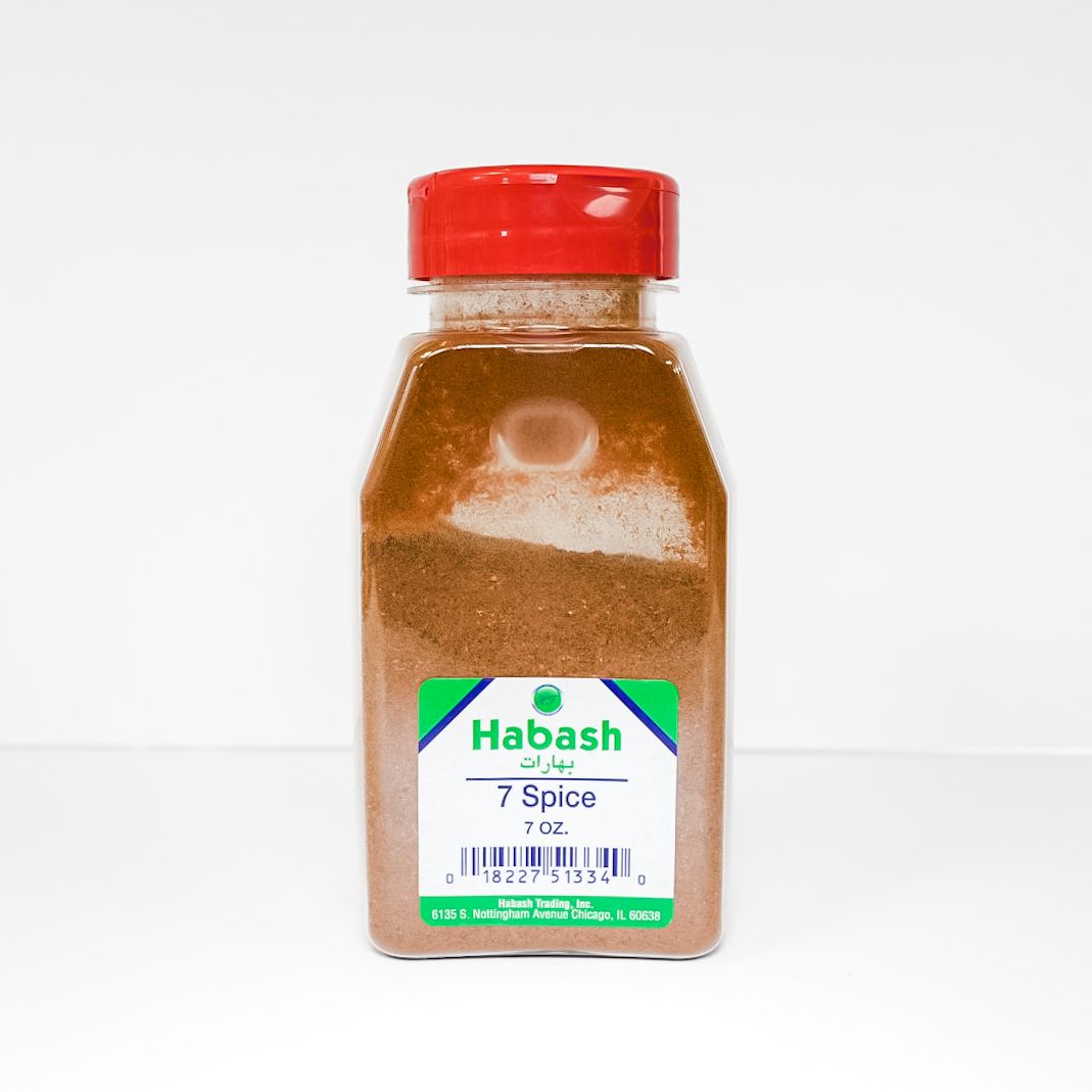 Small spice jar with red cap and Habash label on a white background