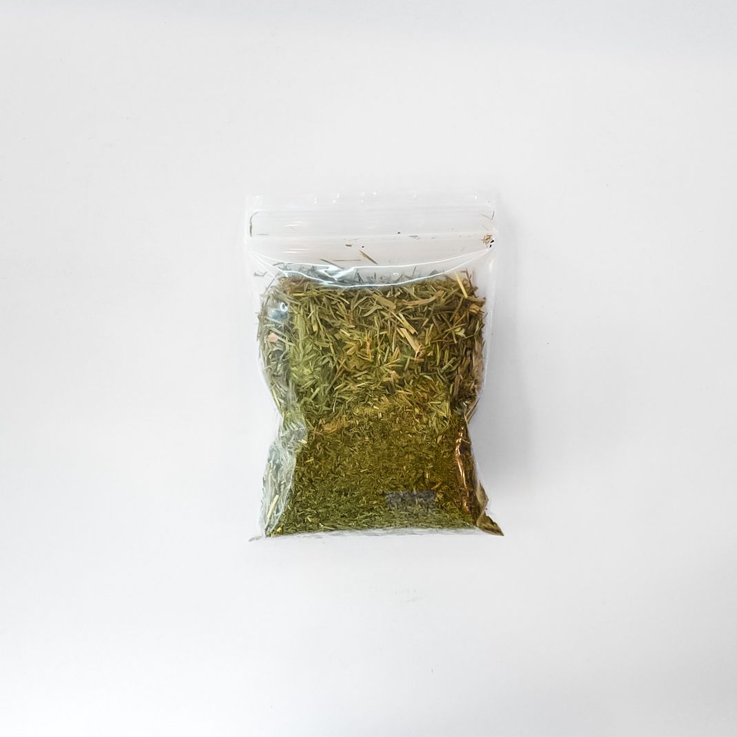 Clear plastic package of dried horsetail herbs with a bright yellow label on a white background