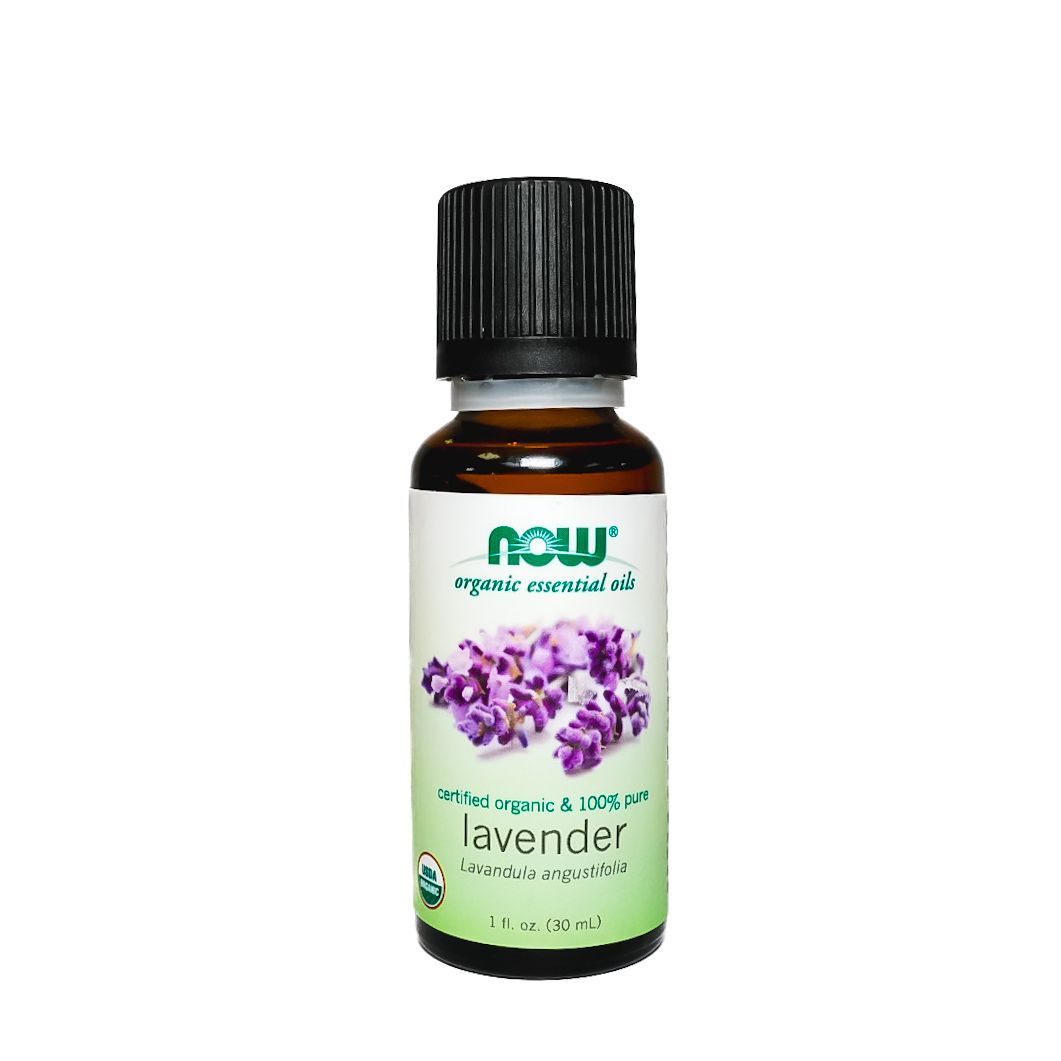 Amber bottle of lavender essential oil with black cap and purple flower label on a white background