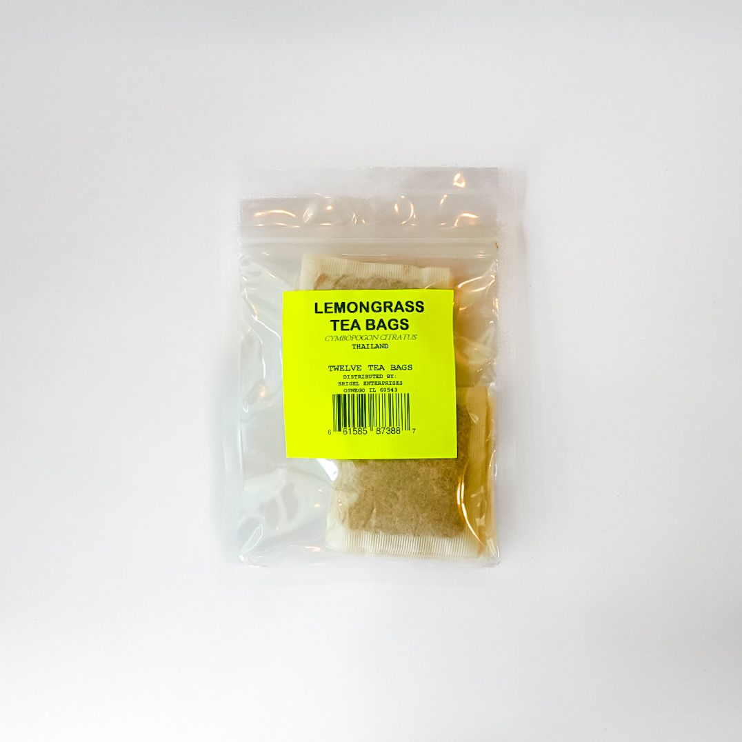 Clear plastic bag of dried lemongrass tea bags with a bright yellow label on a white background