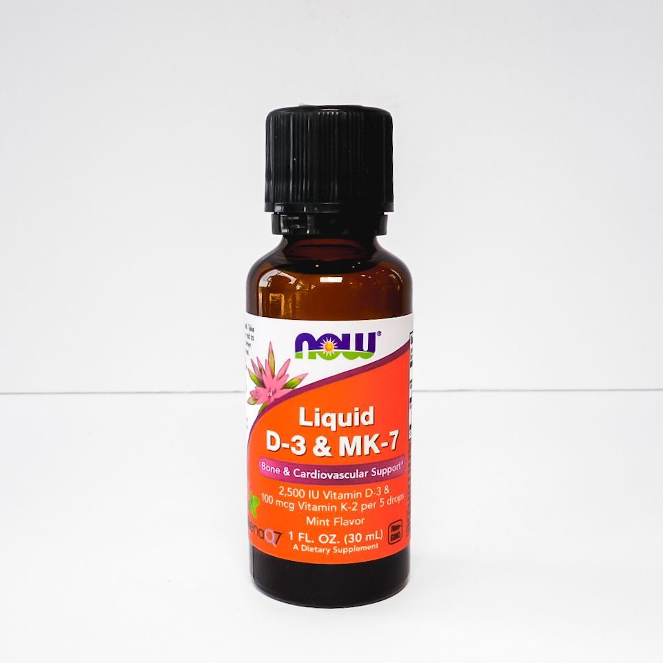 Small amber supplement bottle with black cap and orange label on a white background