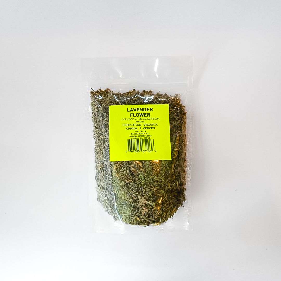 Clear plastic bag of dried herbs with a bright yellow label on a white background