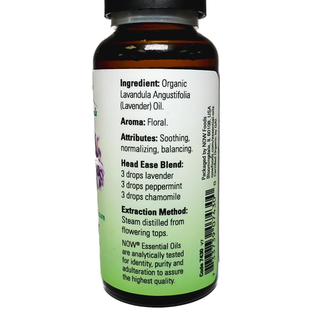 Amber bottle of lavender essential oil with black cap and purple flower label on a white background