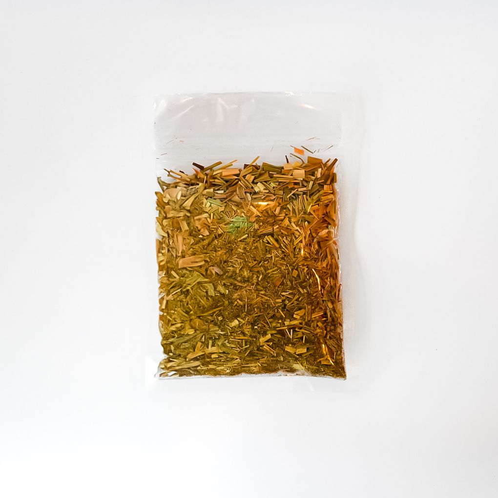 Clear bag of dried lemongrass with a bright yellow label on a white background