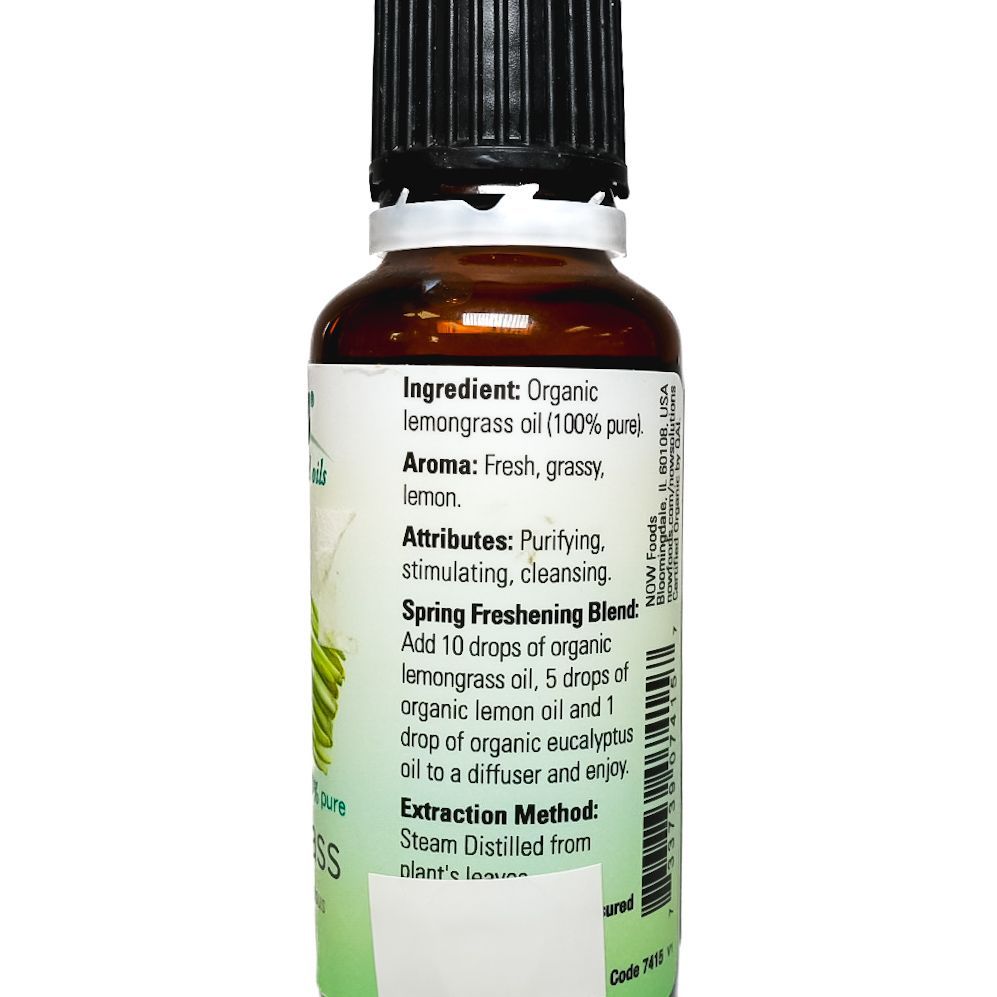 NOW Lemongrass essential oil bottle with black cap and green label on white background