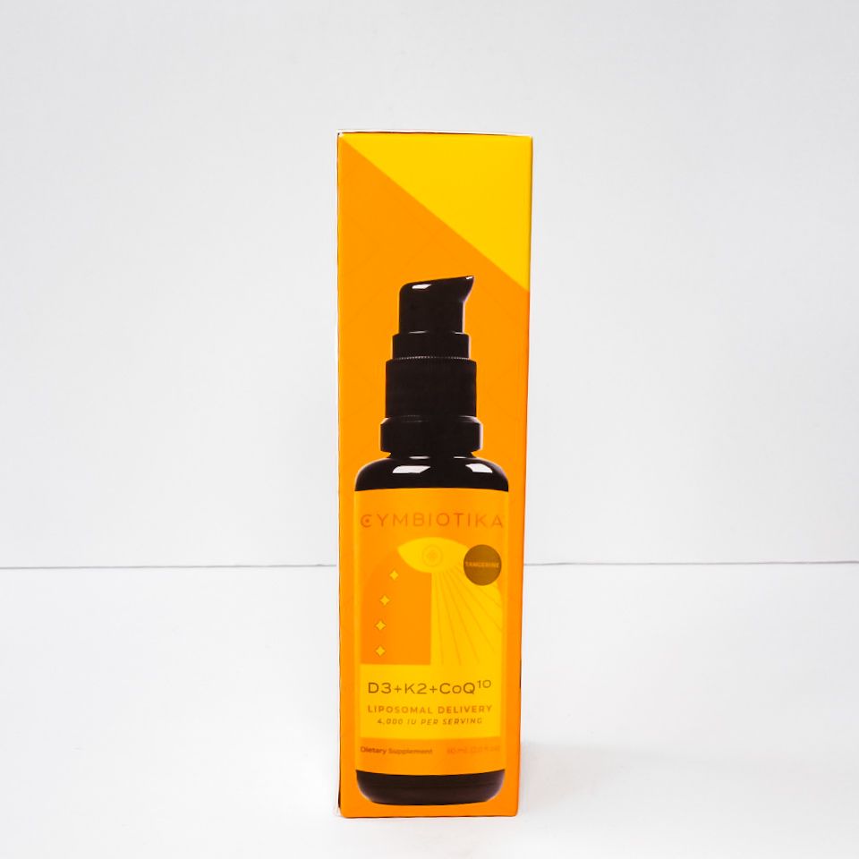 Orange skincare product box with black pump bottle on a white background