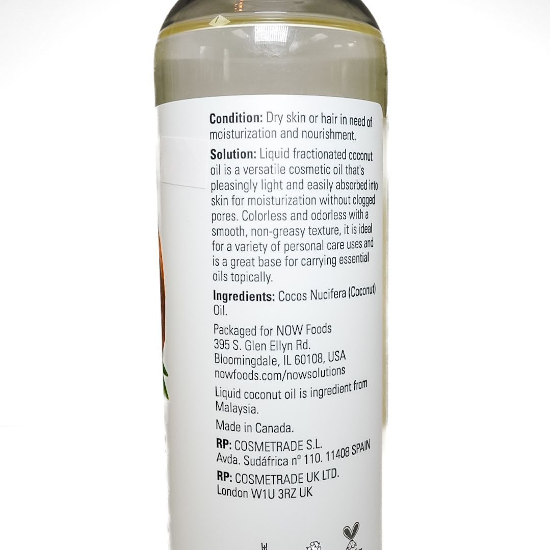 Bottle of coconut oil with a white label and coconut image on a plain background