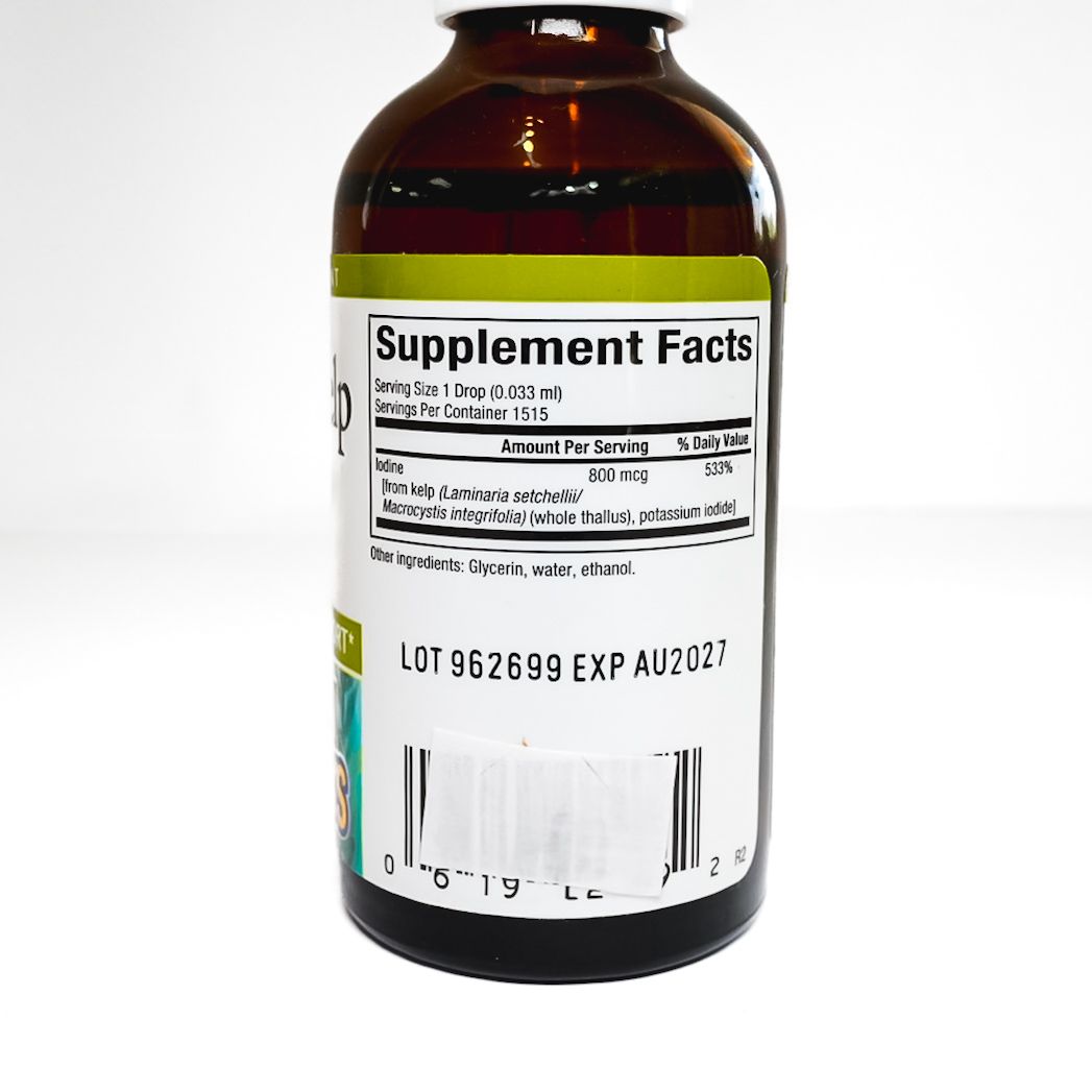 Small brown Liquid Kelp supplement bottle with white dropper cap and green label on white background
