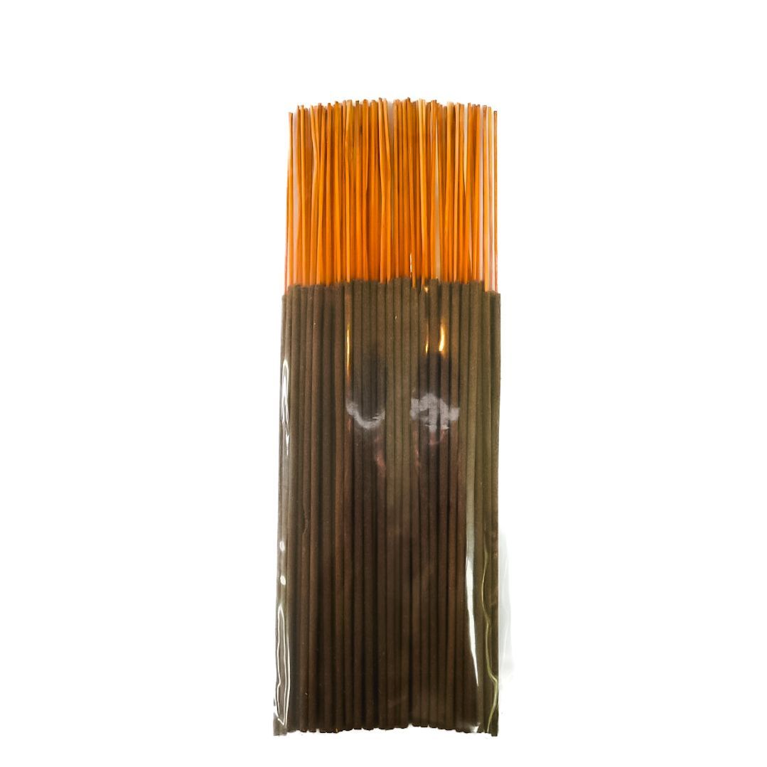 Bundle of brown incense sticks with a yellow label, isolated on a white background