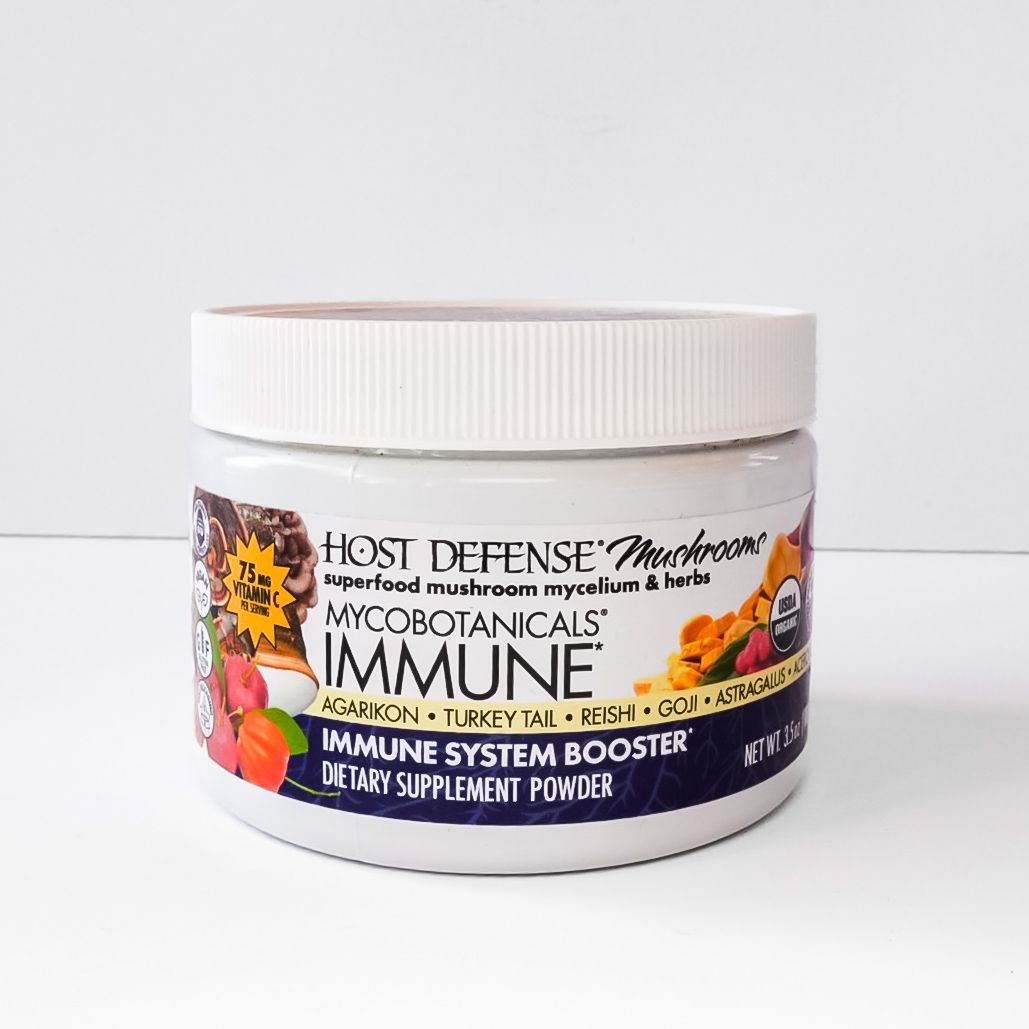 White jar of Host Defense MycoBotanicals Immune mushroom supplement powder on a white background