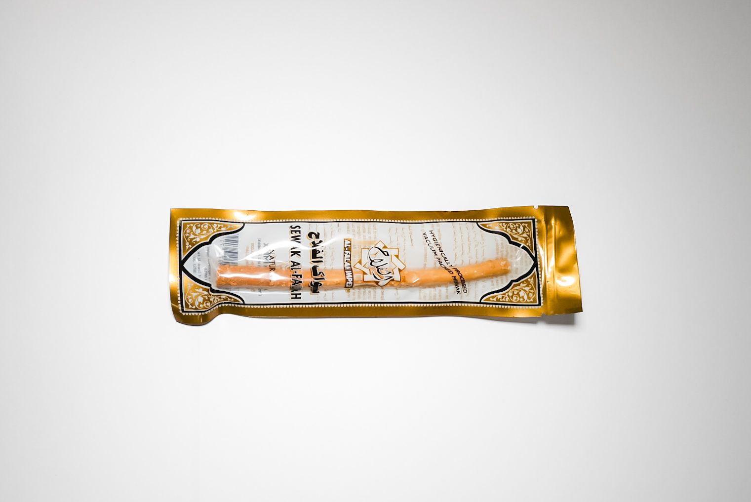Gold-wrapped snack bar with white center on a plain white background