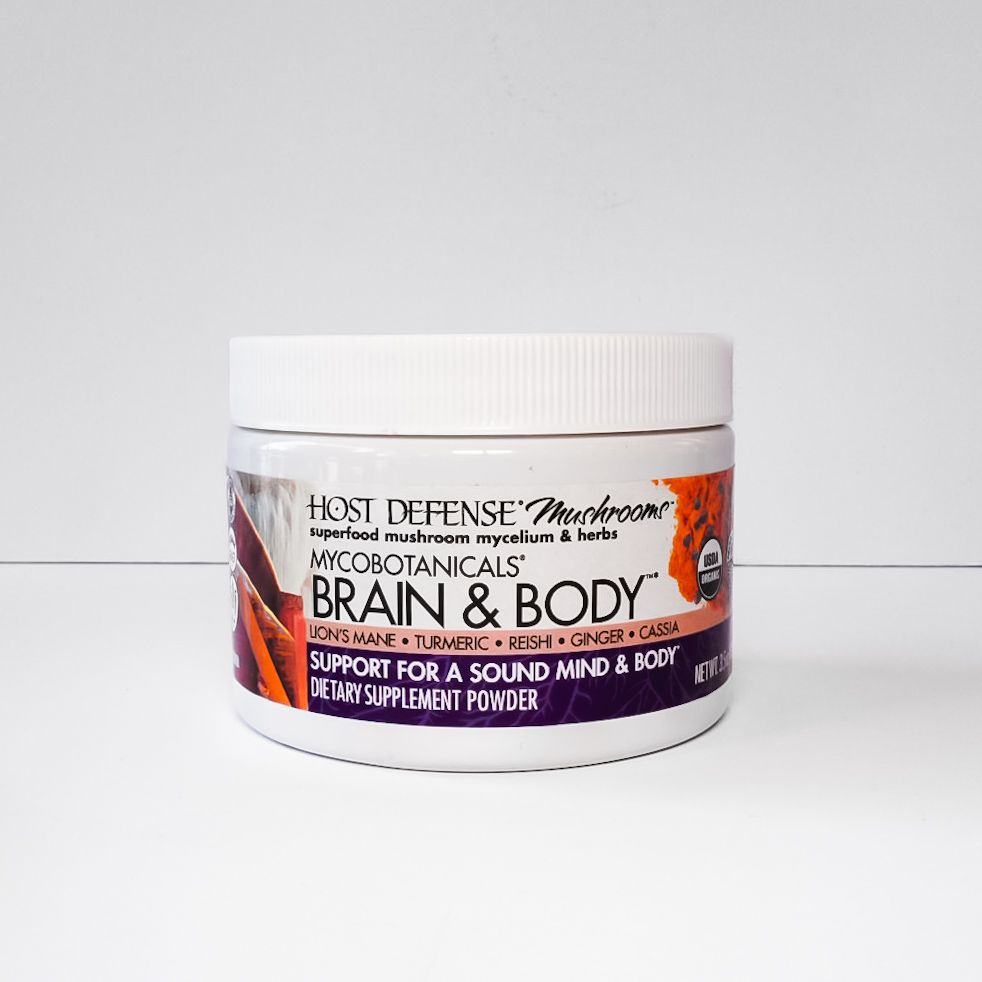 White jar of Host Defense MycoBotanicals Brain & Body supplement on a light background