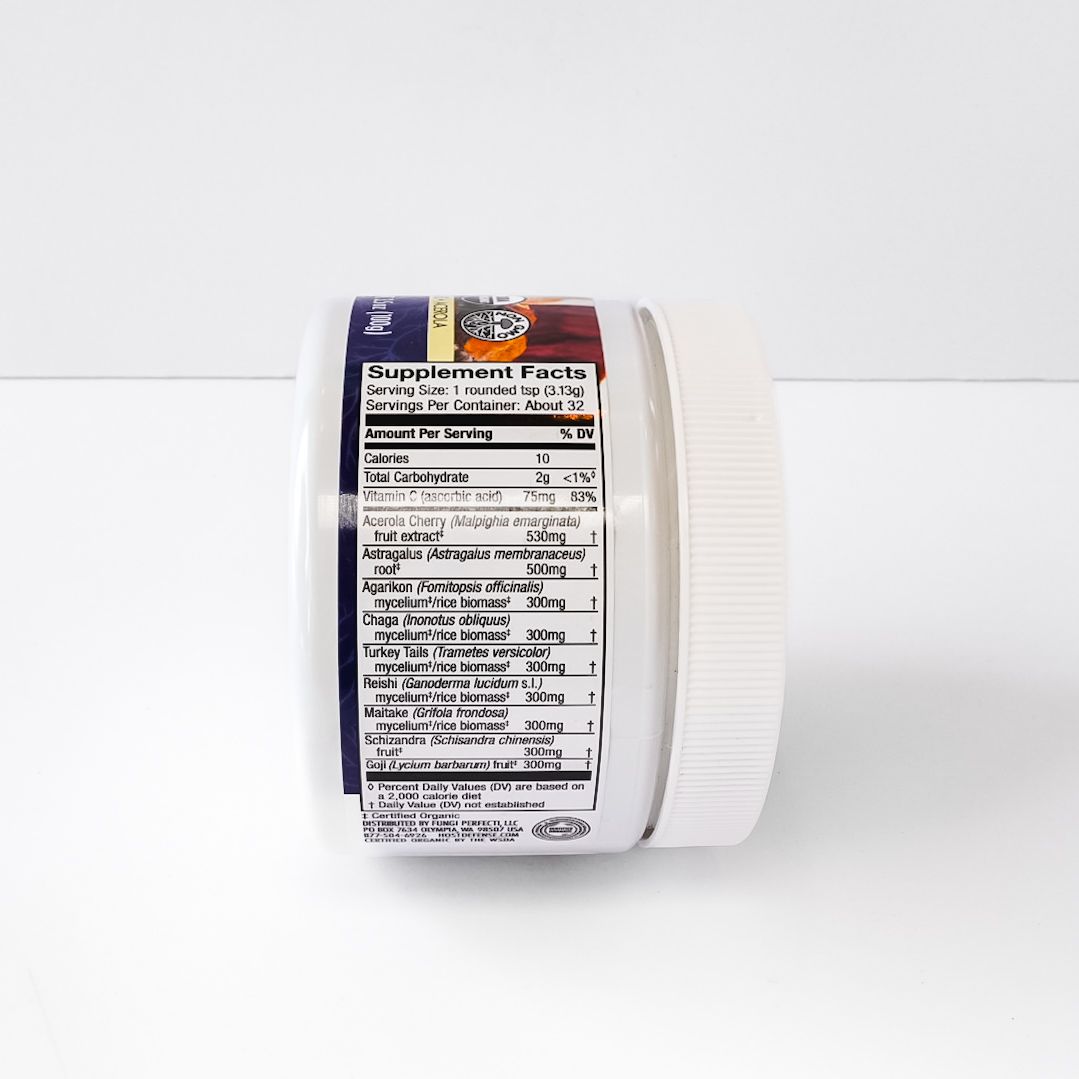 White jar of Host Defense MycoBotanicals Immune mushroom supplement powder on a white background