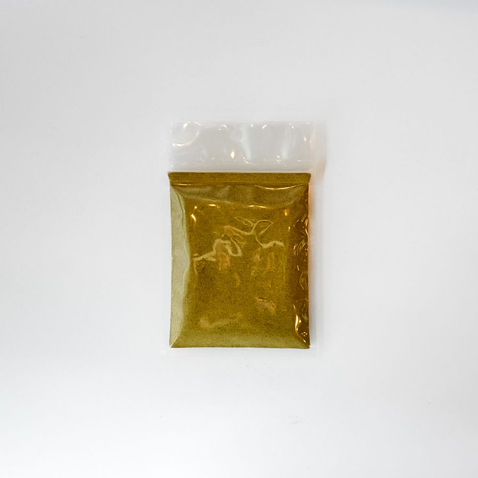 Small clear plastic bag of yellow powder with a bright yellow label on a white background